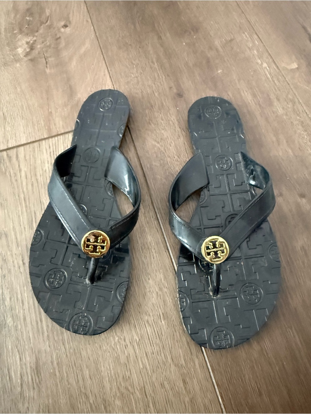 Tory Burch Black Flip Flop Sandals with Gold Logo Medallion